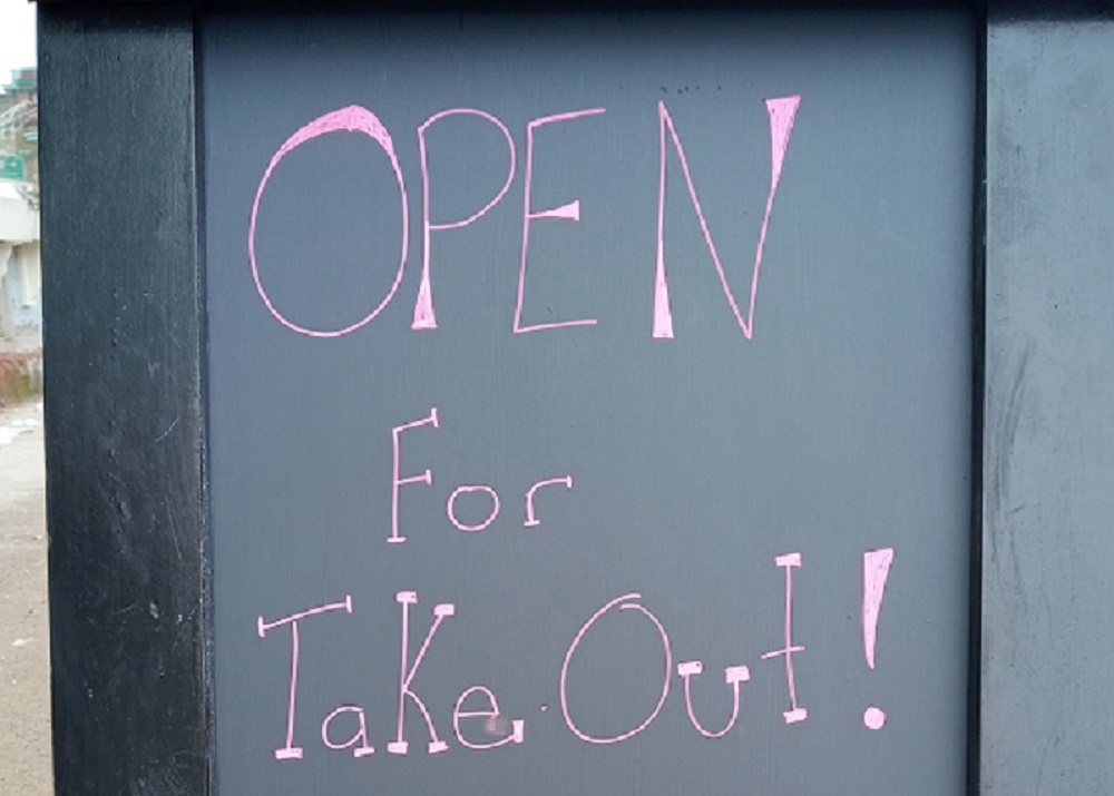 A street sign says "Open for takeout!"