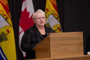Minister of Health Dorothy Shephard speaks behind a podium.