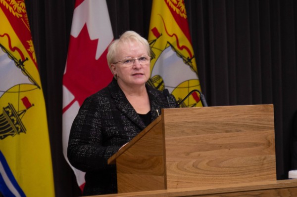 Minister of Health Dorothy Shephard speaks behind a podium.