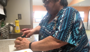 A still of Deanna Cadman chopping a potato.