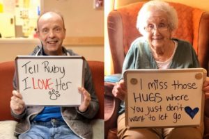 A collage of two elderly people holding whiteboard signs. The person on the left holds a sign that says "Tell Ruby I love her" with a drawing of a pawprint. The person on the left holds a sign that sys "I miss those HUGS where you just don't let go" with a drawing of a heart.