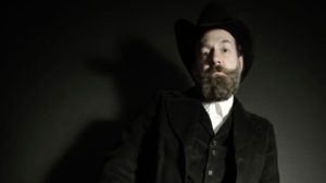 Jason Haywood wears button shirt and hat